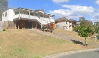Sloping front yard of a Gold Coast home before retaining wall construction